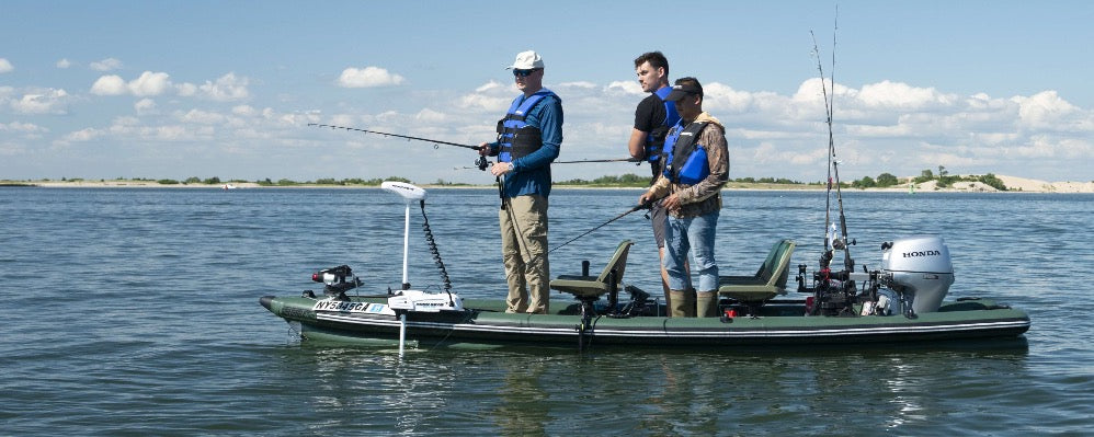 Inflatable boat rigged with trolling motor and portable outboard.